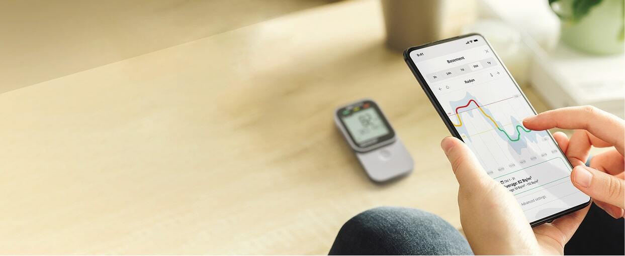 Airthings Corentium Home 2 radon detector with app displaying sensor readings
