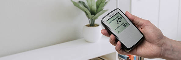 Man holding a handheld Radon detector