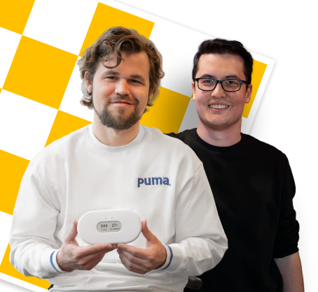 Magnus Carlsen & David Howell holding Airthings indoor air quality monitors